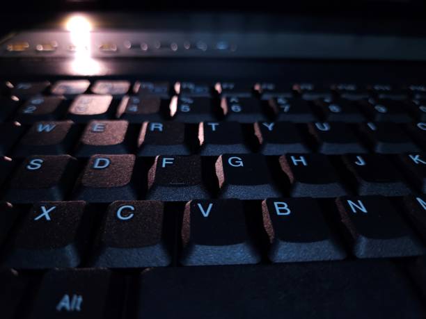 istock Close-up of computer keyboard in dark background. 2194654422