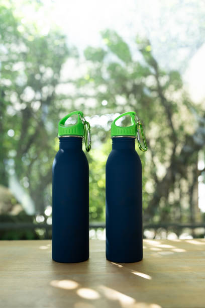 istock Two blue minimal reusable water bottle is sitting on a wood table. 2194655931