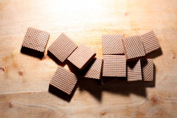 Delicious crispy wafer chocolate on wooden table