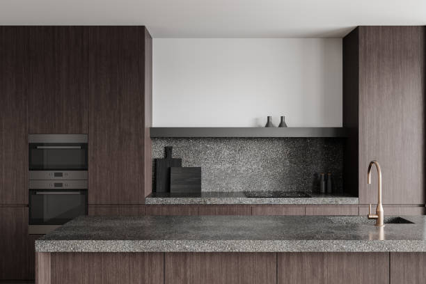 Contemporary kitchen design featuring dark wood cabinetry, terrazzo countertop, and backsplash. Minimalist decor with a clean white wall background. 3D Rendering.