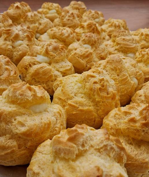 istock Light and airy choux pastry with a golden crust, filled with rich cream or custard. This elegant and versatile dessert offers a perfect balance of texture and sweetness. 2194662448