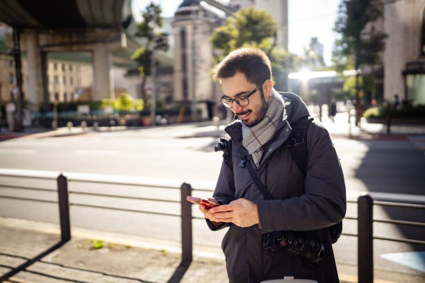 istock Man using mobile phone in city street. 2194663120