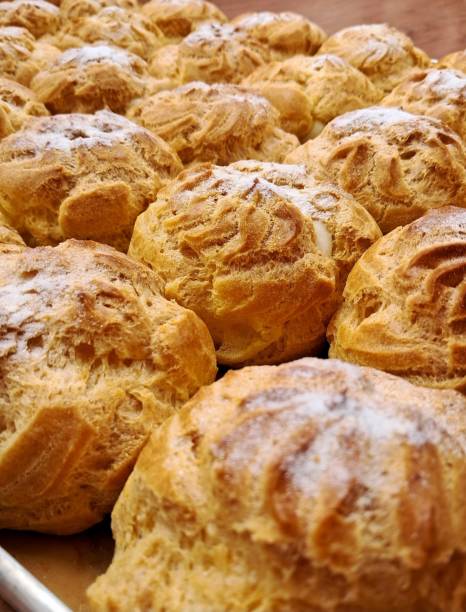 istock Light and airy choux pastry with a golden crust, filled with rich cream or custard. This elegant and versatile dessert offers a perfect balance of texture and sweetness. 2194663575