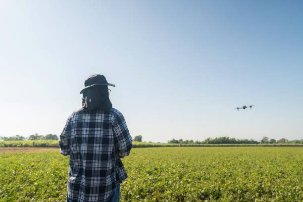 istock Man farmer and controlling of drone which flying above margin. 2194663778