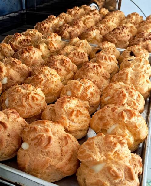 istock Light and airy choux pastry with a golden crust, filled with rich cream or custard. This elegant and versatile dessert offers a perfect balance of texture and sweetness. 2194663786
