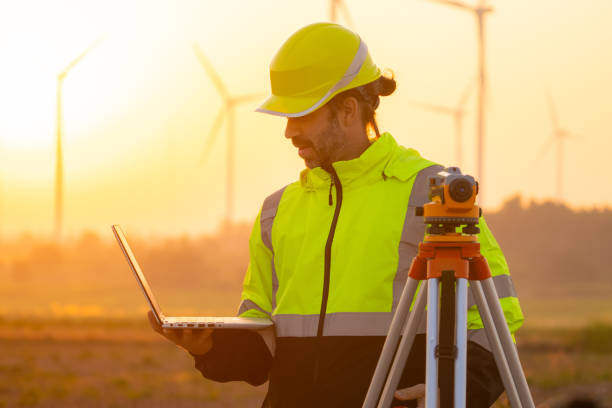 istock Engineer working on laptop checking wind turbines of the field. 2194663848