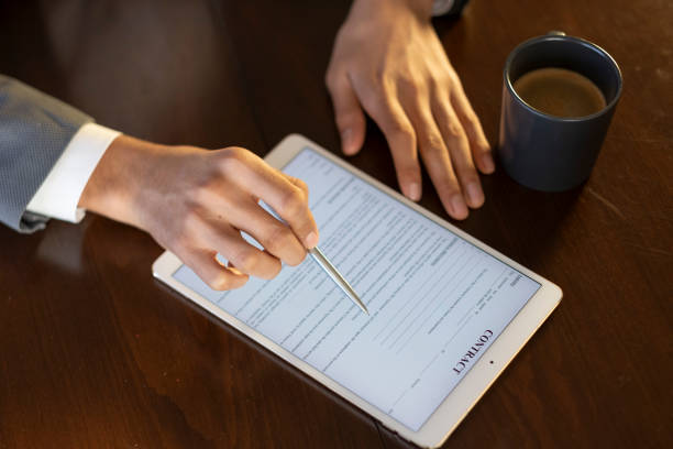 istock Businessman reviewing contract on digital tablet with stylus 2194664715
