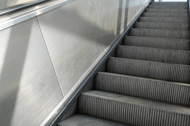 istock Escalator steps, moving staircase, empty metro elevator, electric stairway, metallic moving stairs 2194664760