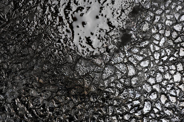 Texture of burnt organic matter. Carbon texture background of black glare color.