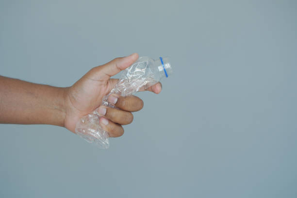 istock A person is grasping a plastic bottle with their fingers and thumb 2194668316