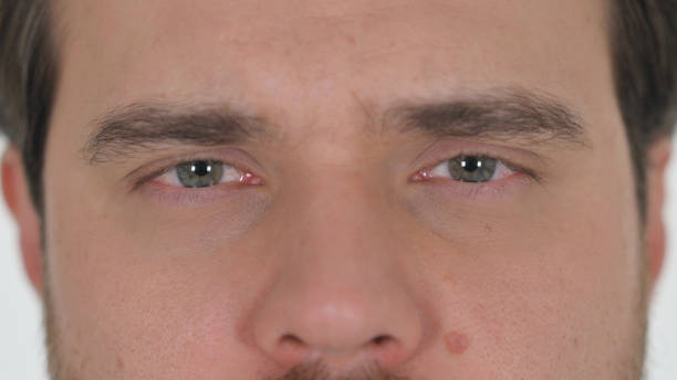 istock Close up of Man Blinking Eyes on White Background 2194669555