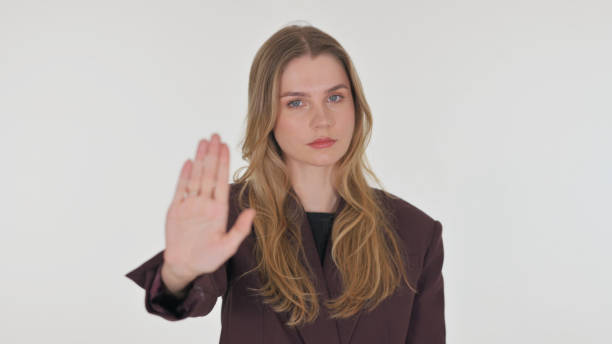 istock Stop Gesture by Young Woman on Green Background 2194669695