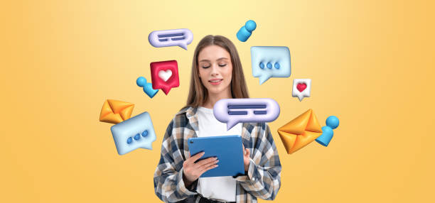 istock Woman using tablet surrounded by vibrant 3D social media icons o 2194670521