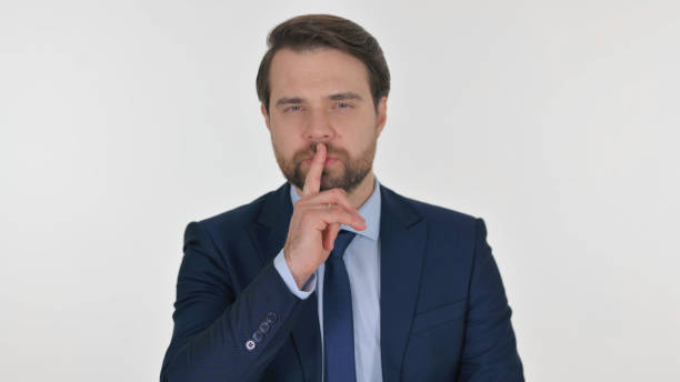 istock Middle Aged Businessman with Finger on Lips on White Background 2194670938