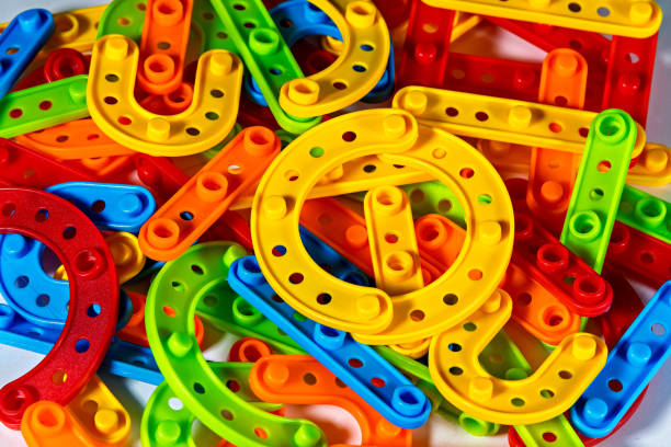 A pile of colorful plastic horseshoes on a white surface stock photo