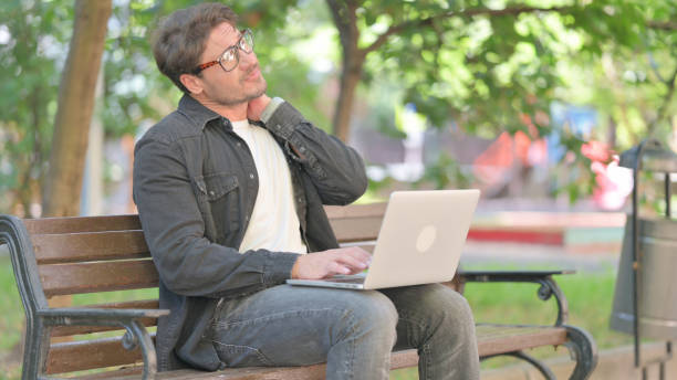 istock Tired Middle Aged Man Using Laptop Restless Outdoor 2194673394
