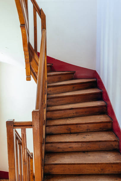 istock Winding wooden staircase in an old building 2194675546