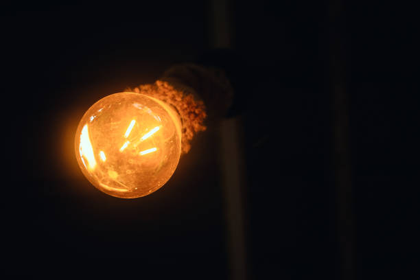 Vintage light bulb in the dark room. Selective focus.