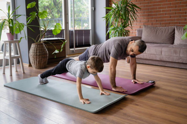 istock Father And Little Son Doing Home Exercises 2194679322