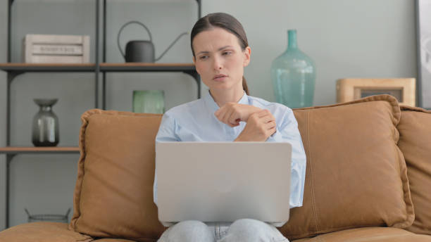 istock Woman with Wrist Pain Using Laptop at Home 2194679509