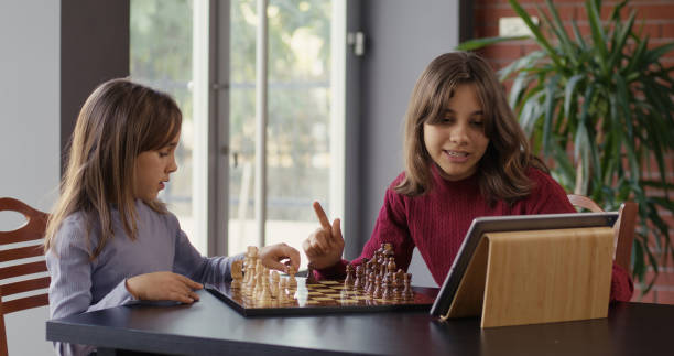 istock Two Child Girls Playing Chess Together 2194680862