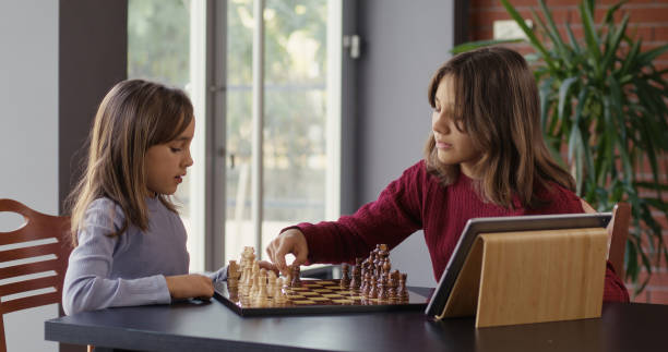 istock Two Child Girls Playing Chess Together 2194681006