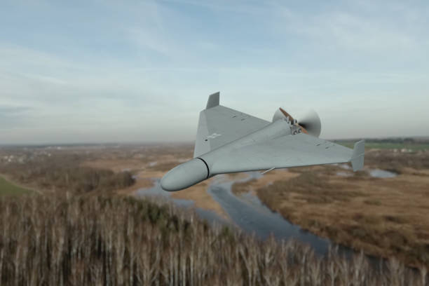 istock Military drone in the sky over forest and river. 2194681755