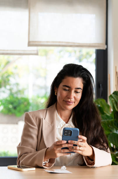 istock Businesswoman using smartphone at brunch table 2194682333