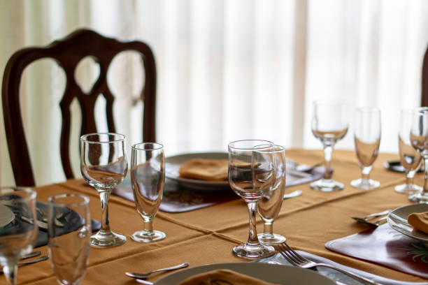 istock A table with a chair and a tablecloth with a few glasses and utensils 2194683684
