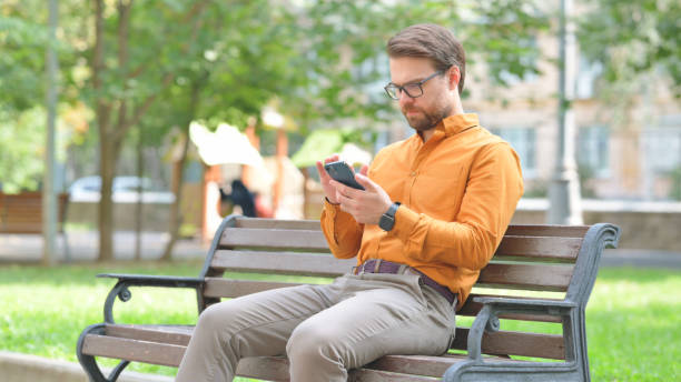 istock Young Man Browsing Internet on Smartphone Outdoor 2194685659