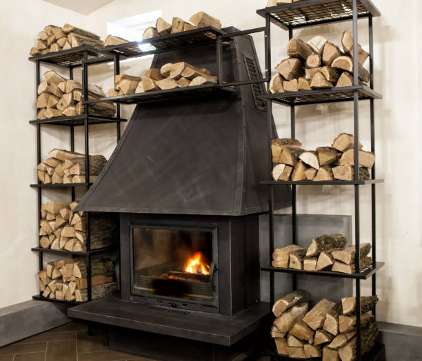 istock Stylish interior element with a fireplace and shelves for firewood. Interior of a fireplace area for a bar, cafe, restaurant in a modern style. 2194687104
