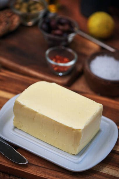 Block of Butter on a White Plate with Rustic Kitchen