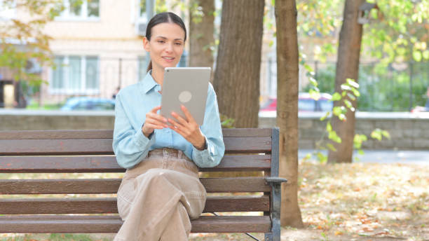 istock Video Chat on Tablet by Young Woman Outdoor 2194687787