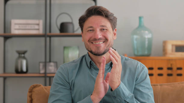 istock Portrait of Excited Middle Aged Man Clapping while at Home 2194689338