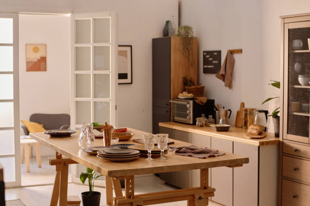 istock Served Table in Cozy Kitchen Equipped with Wooden Furniture 2194689366