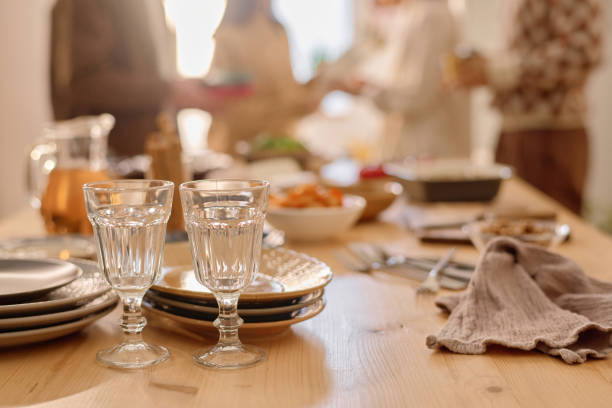 istock Polished Glasses and Plates on Wooden Table 2194689427