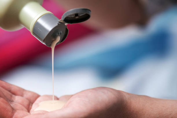 istock hand pouring pine balm from a green plastic bottle onto the palm. The image captures the essence of natural remedies and self-care routines 2194689520