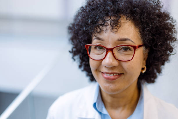 istock Smiling doctor wearing glasses and lab coat looking at camera 2194689953