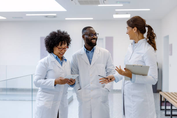 istock Medical team discussing diagnosis in hospital corridor 2194689999
