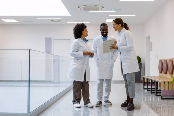 istock Multi-ethnic doctors discussing medical records in hospital corridor 2194690000
