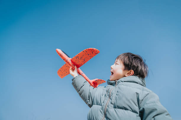istock Lovely kid playing with airplane toy 2194690158