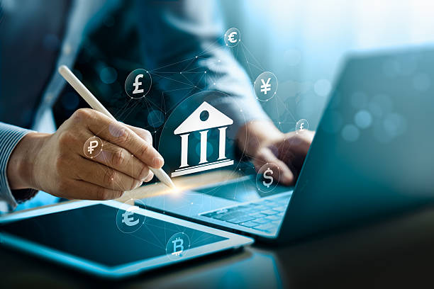 istock Innovative Digital Banking Interface Showcasing Global Currency Exchange and Cryptocurrency Symbols on a Tablet and Laptop, Representing Financial Technology Trends and the Cashless Economy Future 2194690646