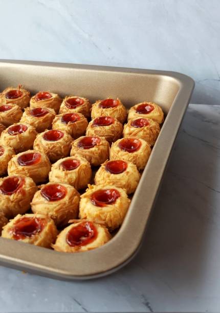 Buttery strawberry thumbprint cookies with a soft, crumbly texture and a sweet strawberry jam center. A delightful treat perfect for tea time or festive occasions.