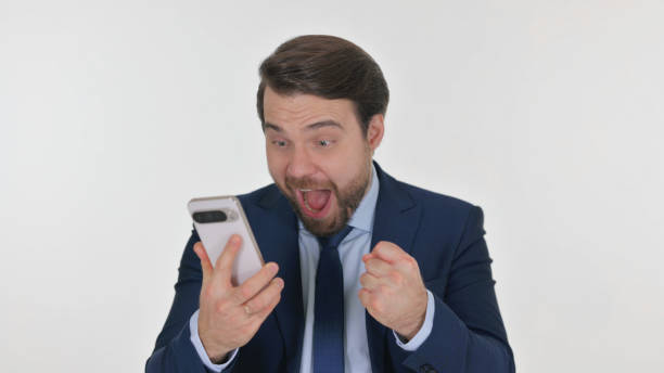 istock Middle Aged Businessman Celebrating Success on Phone on White Background 2194693019
