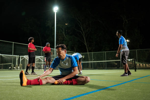 istock Soccer player warming up on a soccer field during training session 2194693996