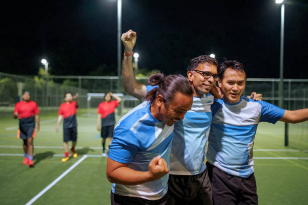 istock Soccer players celebrating goal scored 2194694048