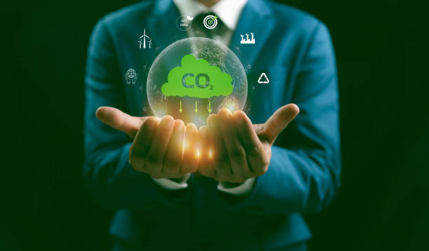 istock A Man hand showing globe with CO2 reducing icon with virtual and carbon credit to limit global warming from climate change concept. World for decrease carbon dioxide emission, carbon footprint. 2194694345