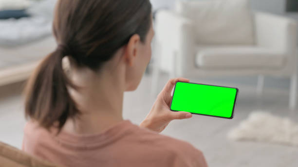 istock Woman Holding Green Chroma Key Smartphone 2194694468
