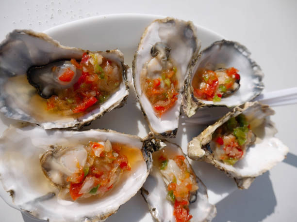 istock Steamed oysters with vegetables in the shells. 2194694576