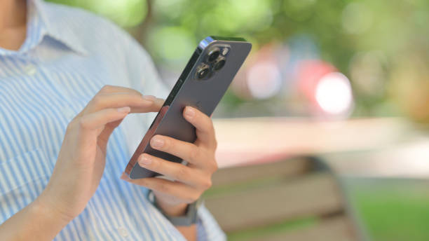 istock Close up of Female Hand Using Smartphone Outdoor 2194698384